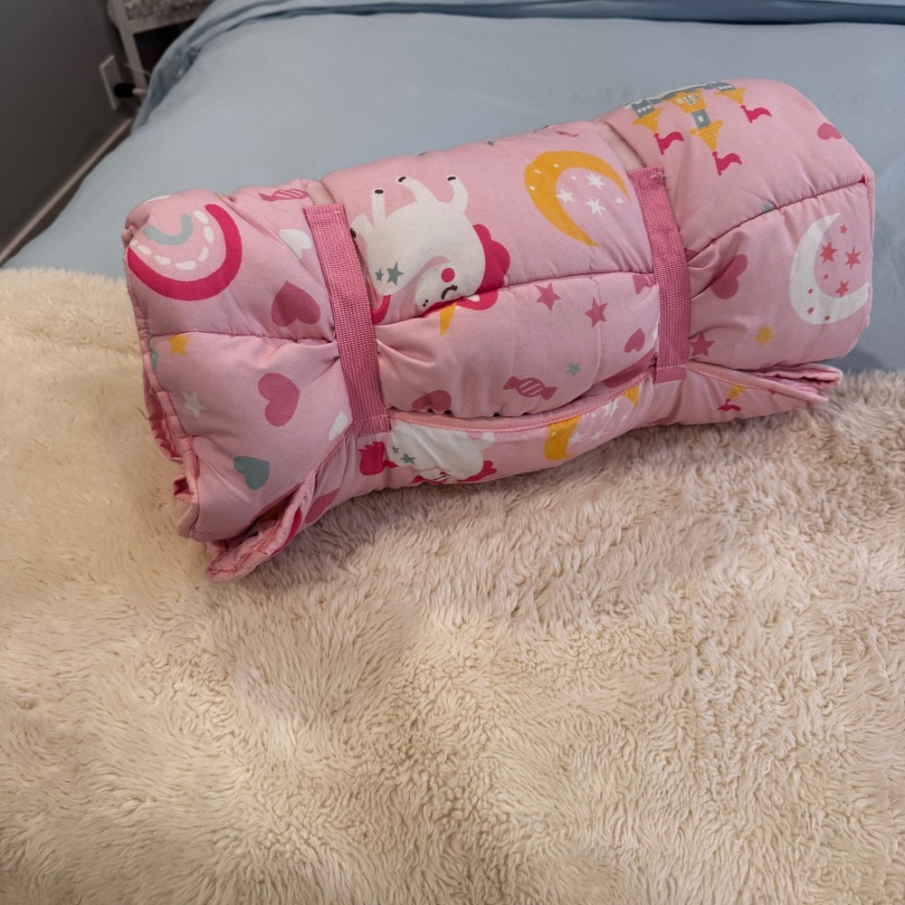 Kids roll in bed with pillow